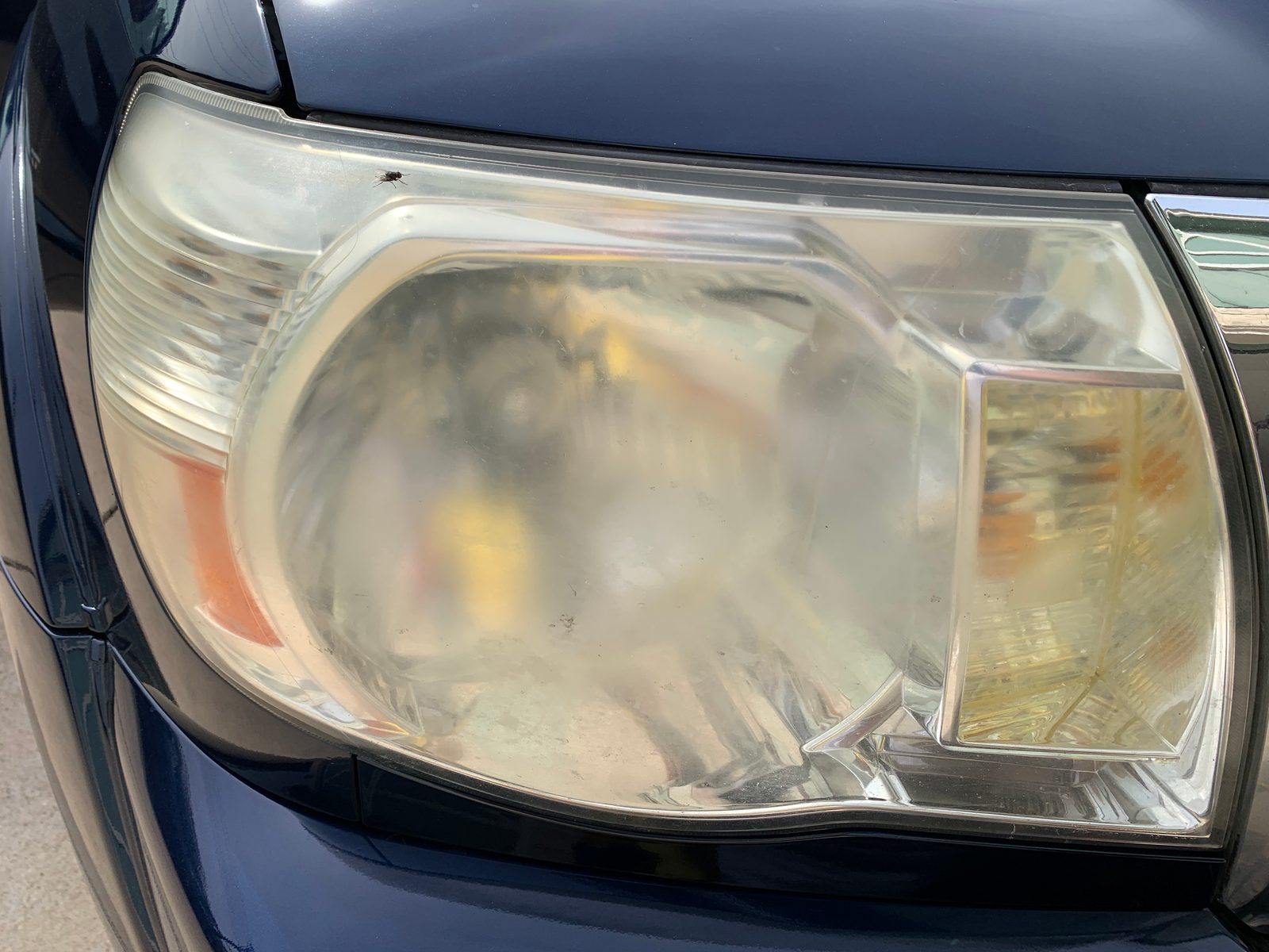 Clouded, yellowed headlight lens before restoration